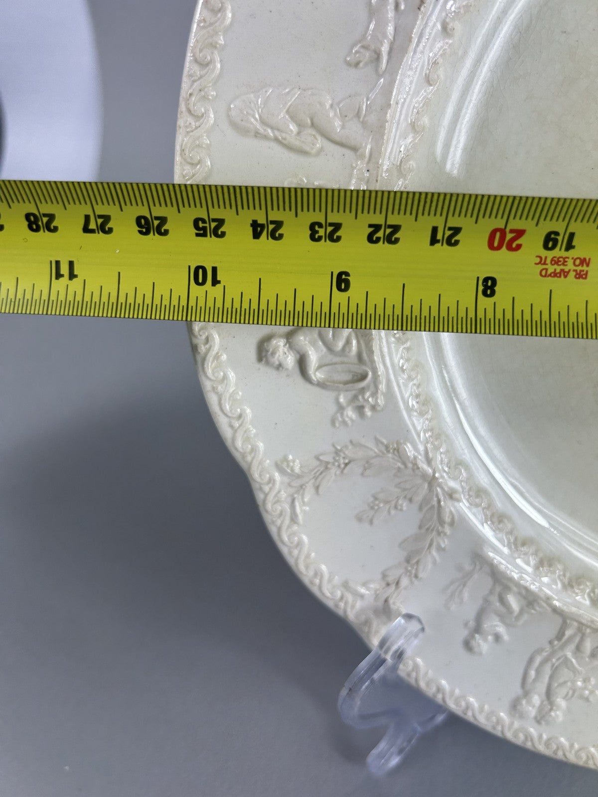 Early Wedgwood creamware plate with moulded putti border, 26cm
