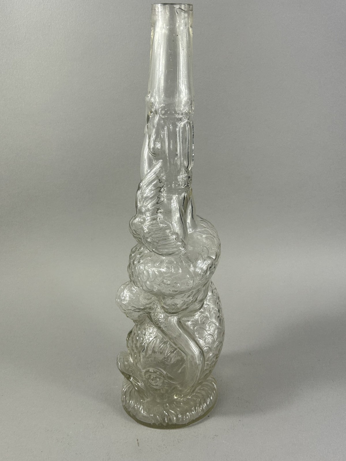 Antique clear glass snake and dolphin liquor bottle, 37cm crafts display