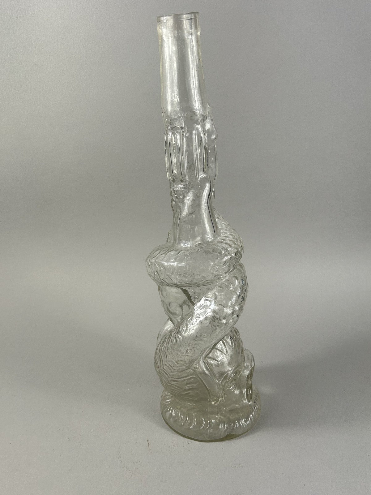 Antique clear glass snake and dolphin liquor bottle, 37cm crafts display
