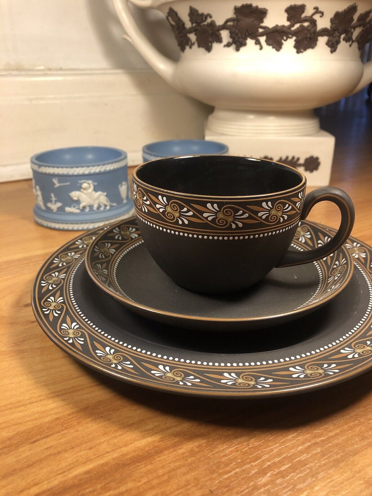 Wedgwood painted trio basalt cup and saucers